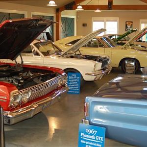 Wilsonville, Oregon - Car barn features beamed ceilings, carriage doors, custom signs, lighting and polished concrete floor provided by Vault (www.sho